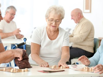 Senior people playing lotto at care home