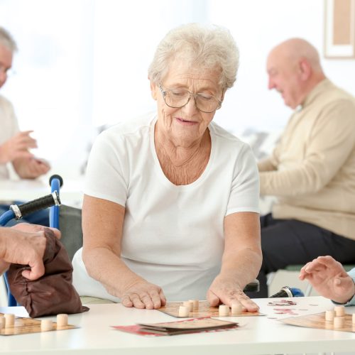 Senior people playing lotto at care home